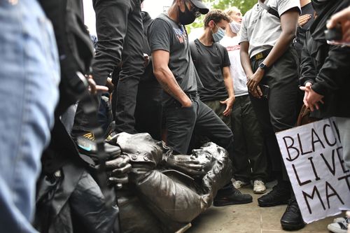 Protesters drag the statue of slave trader Edward Colston down to the harbour.