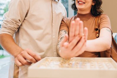 Young couple trying rings on a jewelry store