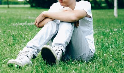 Teenage boy sitting at the park