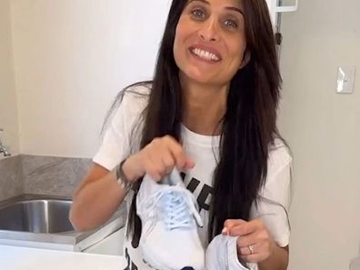 Professional organiser Anita Birges' with sneakers she's just cleaned using a DIY paste.