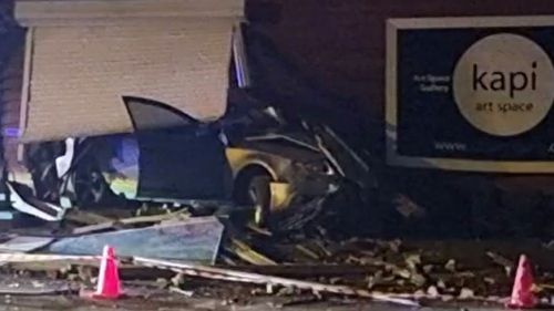 Six teenagers have been arrested after ploughing a stolen Audi through the front of an art gallery in Melbourne. 