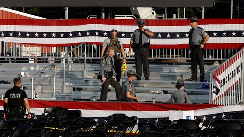 Law enforcement agents pictured near the stage of a campaign rally for Republican presidential candidate former President Donald Trump on July 13, in Butler, Pennsylvania.