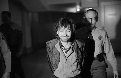 A smiling Charles Manson goes to lunch after an outbreak in court that resulted in his ejection, along with three women co-defendants, from the Tate murder trial, Dec. 21, 1970(AP Photo/George Brich)
