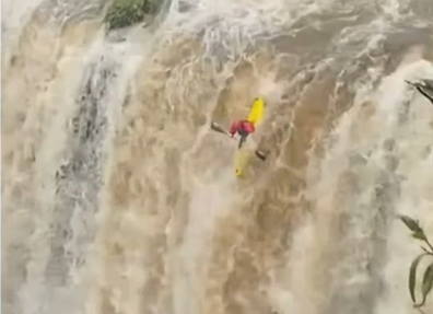 A pair of kayakers have dared a flooded waterfall in NSW.