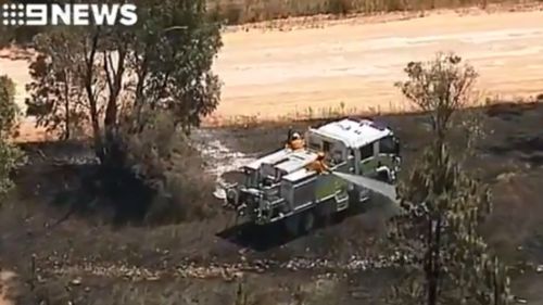 Firefighters continue to work to control the blaze. (9NEWS)