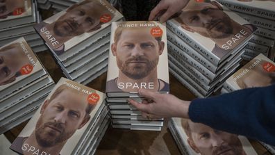 A member of staff places the copies of the new book by Prince Harry called "Spare" at a book store in London, Tuesday, Jan. 10, 2023. 