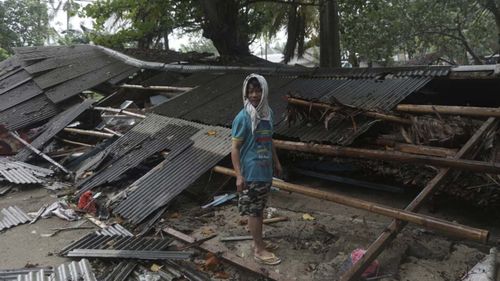 A man inspects his house which was damaged by a tsunami, in Carita, Indonesia.