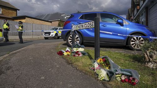 Grieving neighbours have begun laying flowers and handwritten notes at a makeshift memorial on Ashlyn Close