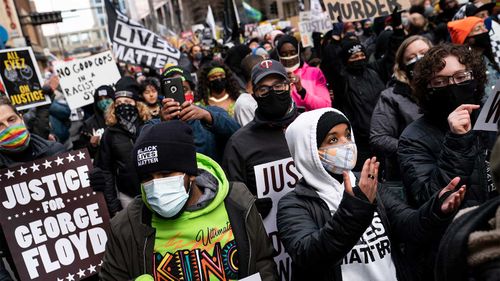 Demonstrators march from Hennepin County Government Centre as the murder trial against the former Minneapolis police officer Derek Chauvin in the killing of George Floyd advances to jury deliberations.