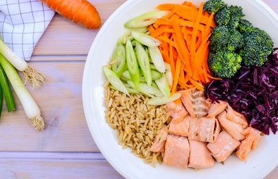 Healthy protein bowl with brown rice, salmon, broccoli