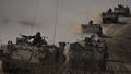 Israeli APCs head toward the Gaza Strip border in southern Israel on Friday, Oct.13, 2023. (AP Photo/Ariel Schalit)