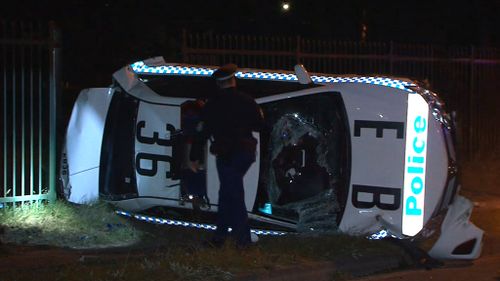 The police car rolled in the crash. (9NEWS)