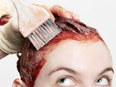 Permanent hair dye being applied with a watchful eye.