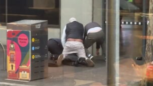 The 55-year-old man was detained by passersby and security until police arrived.