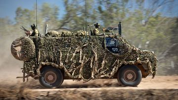 An Australian Army Bushmaster, like that sent to Ukraine, moves off road during a training mission