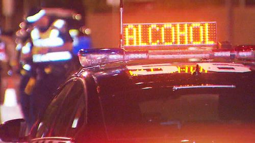 The driver of a red Holden Commodore mounted a footpath, rammed a police car and almost hit a Channel 9 camera man to avoid getting breath tested.