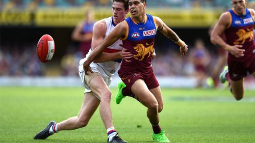 Zaine Cordy (left) of the tackles Allen Christensen of the Brisbane Lions. (AAP)