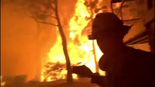 NSW RFS have been filmed battling flames as tall as gumtrees in Blackheath, in the Blue Mountains in a desperate attempt to save someone's home.