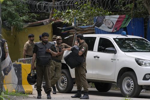 Police officers prepare to take position outside the residence of Pakistan's former Prime Minister Imran Khan, in Lahore, Pakistan, Saturday, Aug. 5, 2023.