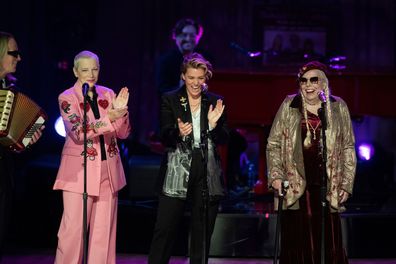 Annie Lennox, left, and Brandi Carlile, center, applaud Joni Mitchell after she sang at the 2024 Library of Congress Gershwin Prize for Popular Song tribute concert honoring Elton John and Bernie Taupin at DAR Constitution Hall on Wednesday, March 20, 2024, in Washington.