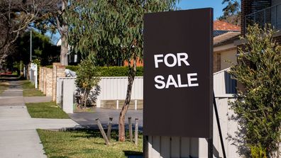 For sale sign on Australian suburban street. 