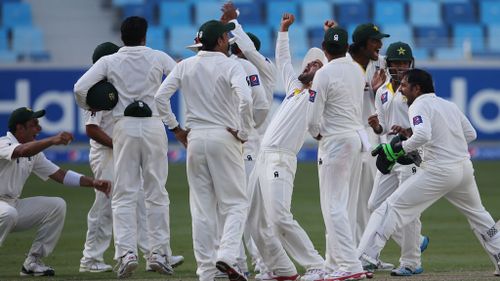 Pakistani players celebrate the dismissal of Australia's Mitchell Johnson. (AP Photo)