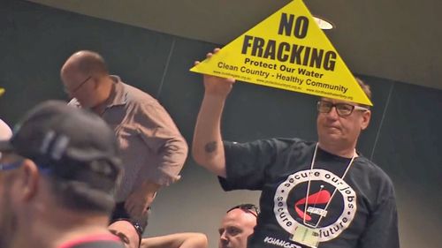 Many in the audience held up "anti-fracking" signs, protesting the NT Government's decision to allow the development of an onshore gas industry. 