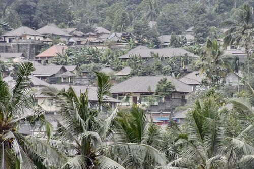 Houses are seen covered in volcanic ash from the eruption of Mount Agung. (AAP)