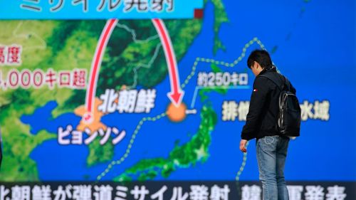 A man stands in front of a huge screen showing TV news program reporting North Korea's missile launch, in Tokyo, Wednesday, Nov. 29, 2017. After 2 ½ months of relative peace, Wednesday’s launch of what the North called the Hwasong-15 intercontinental ballistic missile demonstrated a greater range than other weapons it’s tested and showcased several capabilities the North must master if it were ever to actually try to unleash its missiles at the United States.The Japanese letters on top reads: "Missile luanch." (AP Photo/Shizuo Kambayashi)