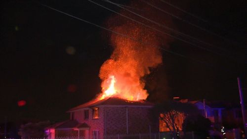 An 86-year-old woman and her 62-year-old son were pulled from their Casula home when it was engulfed in flames overnight. Picture: 9NEWS.