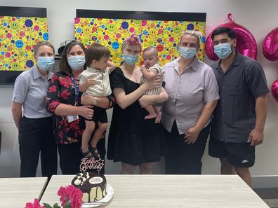 Melanie Thackeray with her partner and children and Mater Brisbane staff 