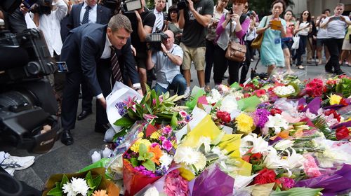NSW Premier Mike Baird lays flowers at the memorial. (AAP)