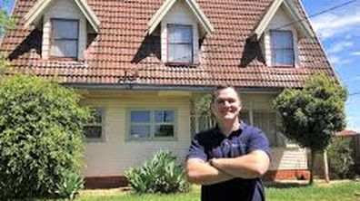 Eddie as a first home owner outside a house in Parramatta. It was his 14th property.