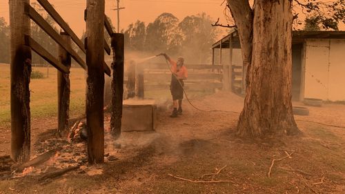 Mogo Wildlife park staff member putting out spot fires