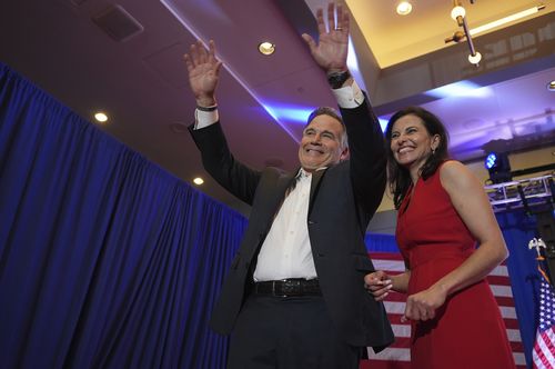 Republican Pennsylvania Senate candidate David McCormick, left, waves to the crowd while on stage with his wife, Dina Powell, during an election night watch party, Wednesday, Nov. 6, 2024, in Pittsburgh. 