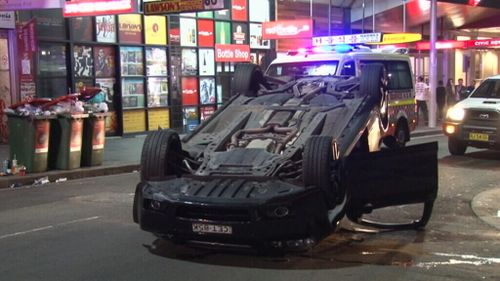 Two men escape car rollover without injury in Sydney CBD