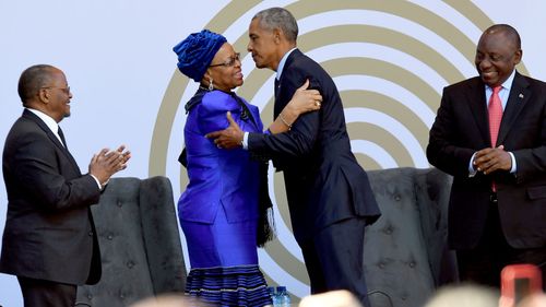 Former US President Barack Obama greets Nelson Mandela's widow Graca Machel, along with South African President Cyril Ramaphosa (far right) and Prof. Njabulo Ndebele (far left) in Johannesburg. (AAP)