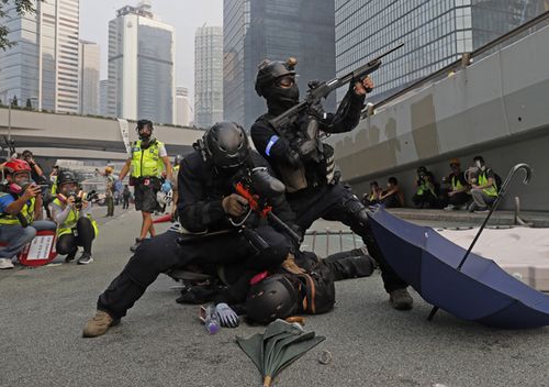 Police detain protestors during the demonstration in Hong Kong. Riot police fired tear gas after a large crowd of protesters at a Hong Kong shopping district ignored warnings to disperse in a second straight day of clashes, sparking fears of more violence ahead of China's National Day.