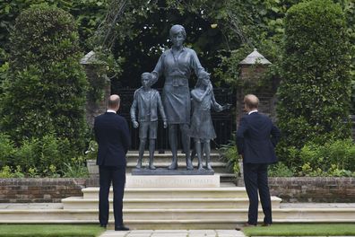 Britain's Prince William and Prince Harry look at the staue they commissioned of their mother Princess Diana,  on what woud have been her 60th birthday, in the Sunken Garden at Kensington Palace, London, Thursday July 1, 2021. (Dominic Lipinski /Pool Photo via AP)