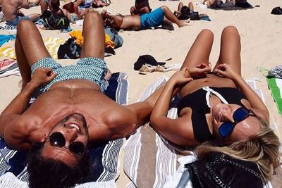 This pair got a <i>little</i> handsy at the beach while getting their "Vit D levels up" in February. <br/> <br/>We vote best-looking couple down at Bondi for sure... <br/>