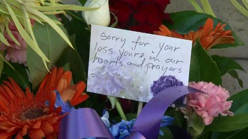 Tributes have been left outside the Parramatta police headquarters. (9NEWS)
