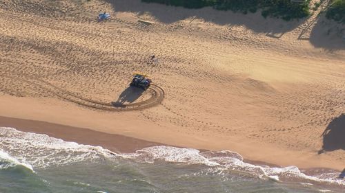 Lifesavers rush to try and help the person who was pulled from the surf at North Palm Beach