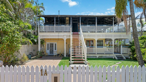 Buyers haggle over Brisbane's half-burnt house as it gets passed in at auction. Negotiations are underway.