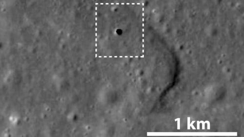 The entrance to the cave as seen from above the surface of the moon. (JAXA)