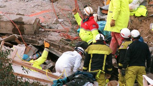 A thumbs up from rescuers offered to sign someone was alive in the rubble.