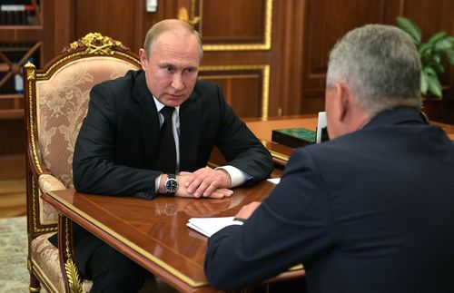 epa07690402 Russian president Vladimir Putin (L) listens to a report of Defence Minister Sergei Shoigu (R) about fire inside deepwater minisubmarine during their meeting at the Kremlin in Moscow, Russia, 02 July 2019. 