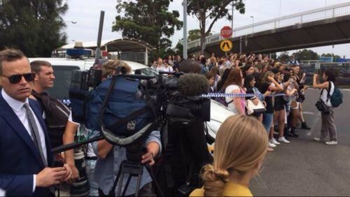 Police tape keeps the ecstatic crowd back as One Direction and 5 Seconds of Summer arrive at Sydney Airport. (Twitter)