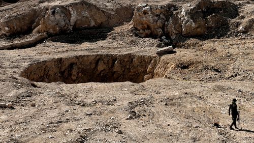 Mass grave horror found beneath the dirt in Iraq