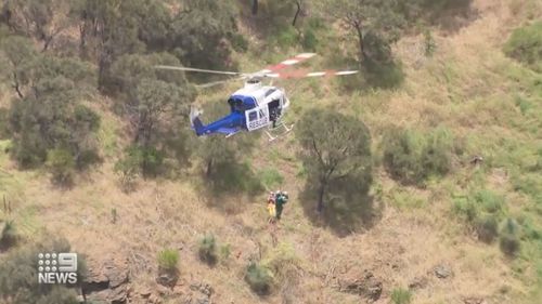 The woman slipped and slid 10 metres down a steep embankment about 8.30am.