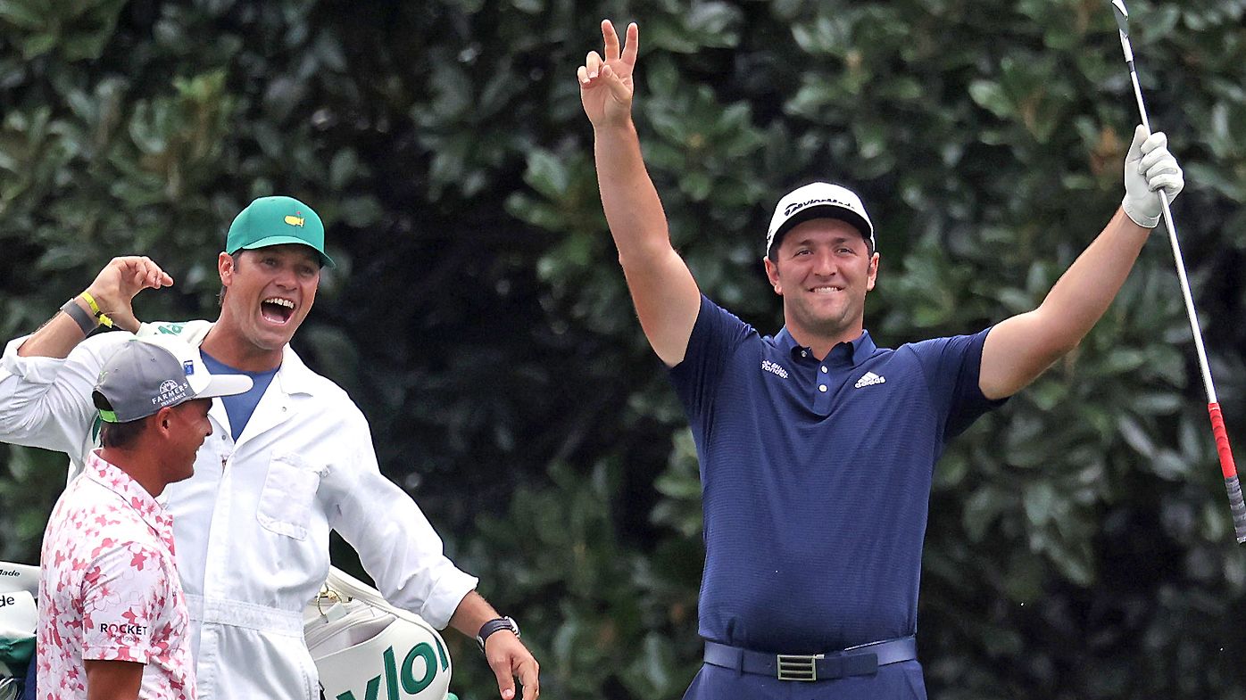 Jon Rahm of Spain celebrates with his caddie Adam Hayes